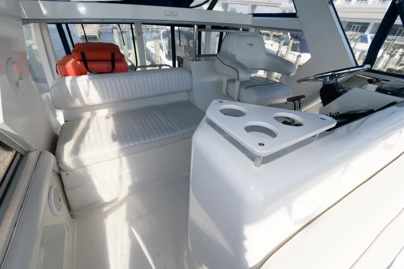 Slide: The Image of 1994 Carver 440 Aft Cabin Motor Yacht interior with seating and helm station. - 10