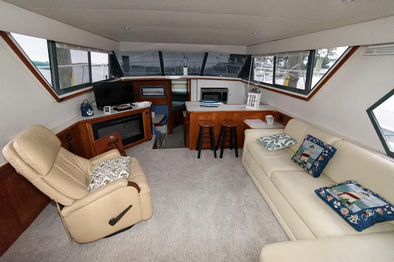 Slide: The Image of Interior of 1994 Carver 440 Aft Cabin Motor Yacht with cozy seating and modern amenities. - 12