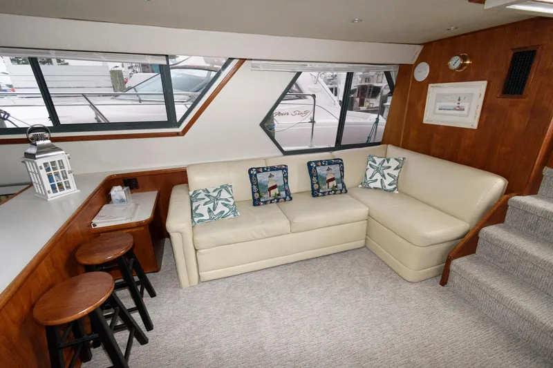 Slide: The Image of Interior of 1994 Carver 440 Aft Cabin Motor Yacht with beige sofa and nautical decor. - 13