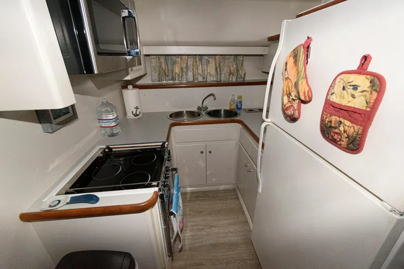 Slide: The Image of Compact kitchen in 1994 Carver 440 Aft Cabin Motor Yacht with stove, fridge, and microwave. - 16