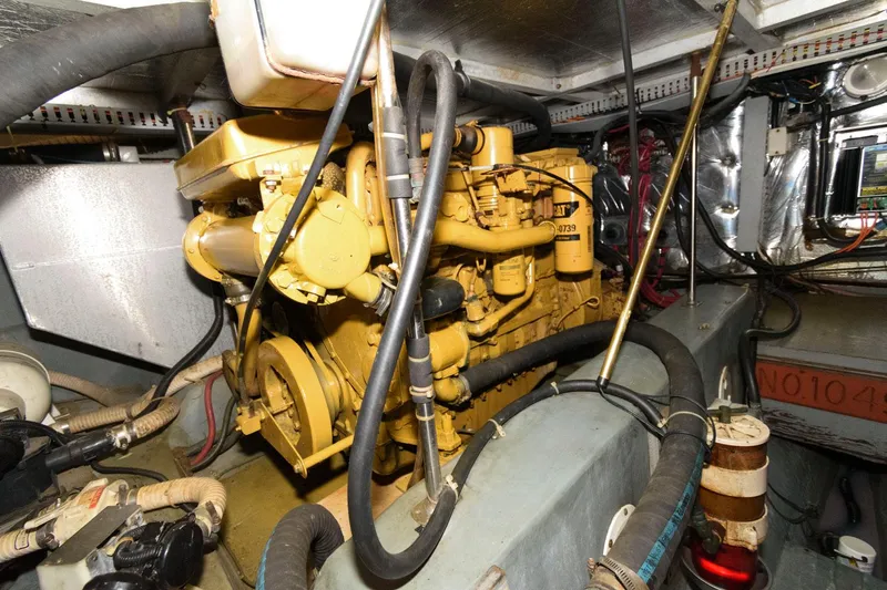 Slide: The Image of Engine room of 1994 Carver 440 Aft Cabin Motor Yacht with visible machinery and components. - 24