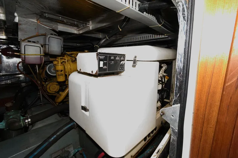 Slide: The Image of Engine room of 1994 Carver 440 Aft Cabin Motor Yacht, featuring generator and machinery. - 26
