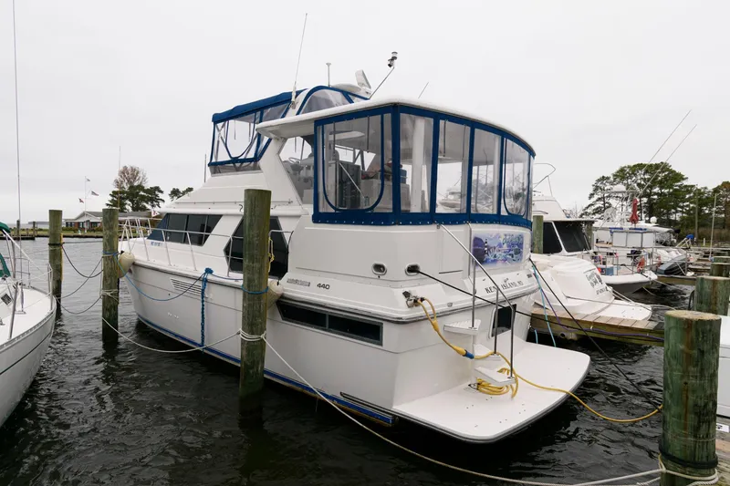 Slide: The Image of 1994 Carver 440 Aft Cabin Motor Yacht docked at marina. - 3