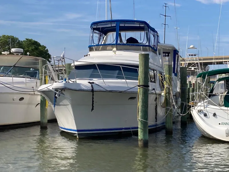 Slide: The Image of 1994 Carver 440 Aft Cabin Motor Yacht docked at marina, surrounded by other boats. - 4