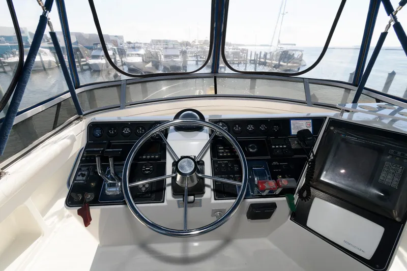 Slide: The Image of Helm of 1994 Carver 440 Aft Cabin Motor Yacht with steering wheel and navigation controls. - 7