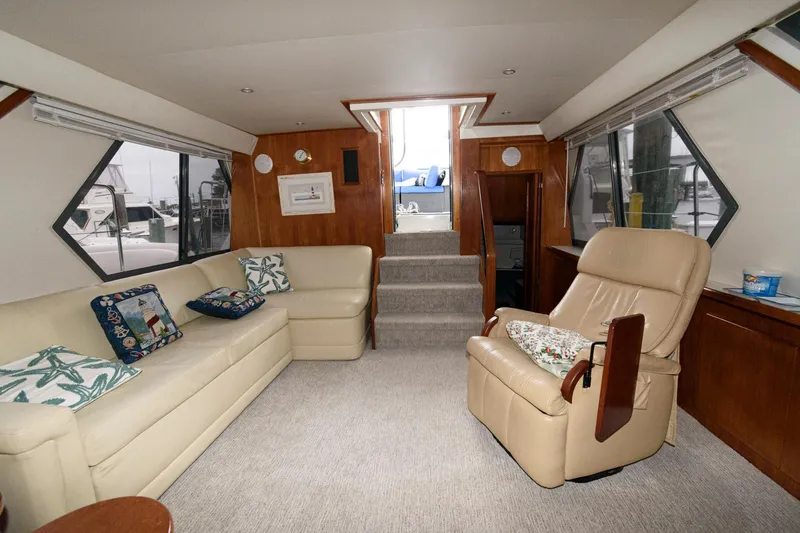 Slide: The Image of Interior of 1994 Carver 440 Aft Cabin Motor Yacht with beige seating and wood accents. - 15
