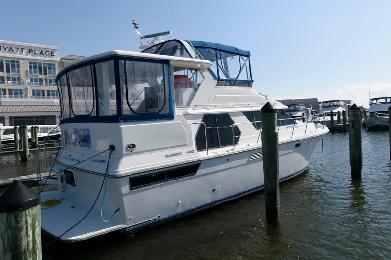 Slide: The Image of 1994 Carver 440 Aft Cabin Motor Yacht docked at marina. - 2