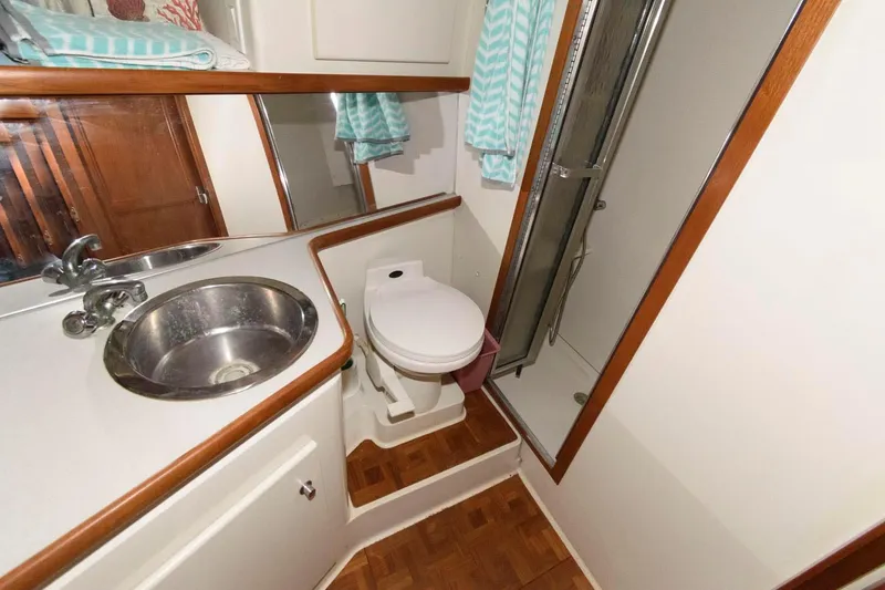 Slide: The Image of Bathroom in 1994 Carver 440 Aft Cabin Motor Yacht with sink, toilet, and shower. - 21