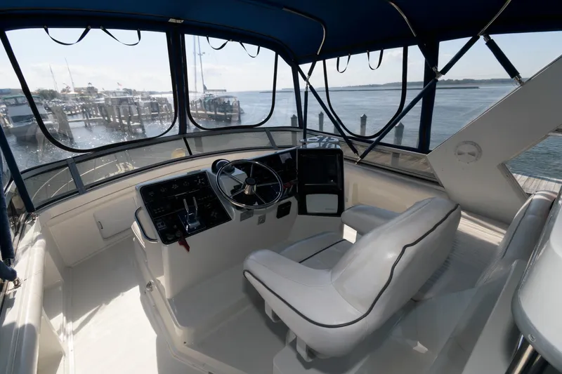 Slide: The Image of 1994 Carver 440 Aft Cabin Motor Yacht helm with waterfront view. - 5