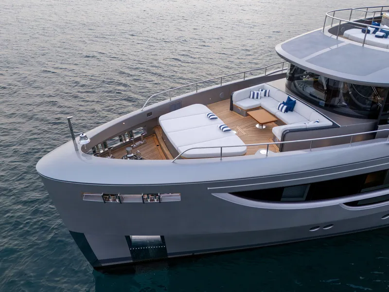 Slide: The Image of Benetti Oasis 34M 2025 yacht with luxurious deck and seating area on calm water. - 9