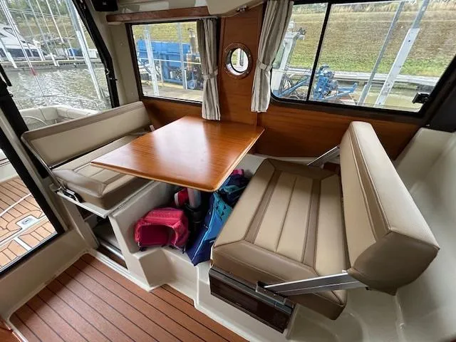 Slide: The Image of Interior of 2023 Ranger Tugs R23 boat with seating and wooden table. - 11