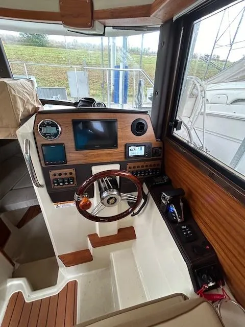 Slide: The Image of 2023 Ranger Tugs R23 boat interior with modern dashboard and steering wheel. - 13
