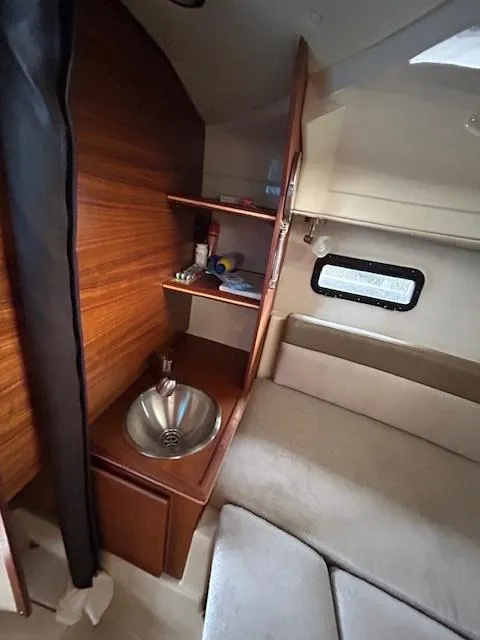 Slide: The Image of 2023 Ranger Tugs R23 cabin interior with sink and seating area. - 19