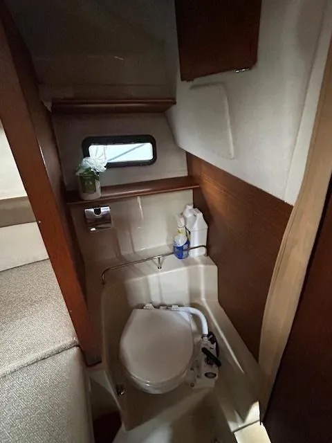 Slide: The Image of 2023 Ranger Tugs R23 boat interior with compact bathroom and window. - 20