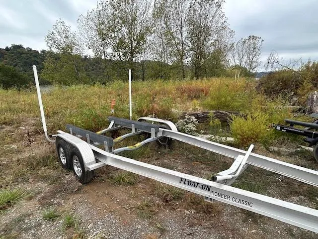 Slide: The Image of Trailer for 2023 Ranger Tugs R23, parked in a grassy area. - 21