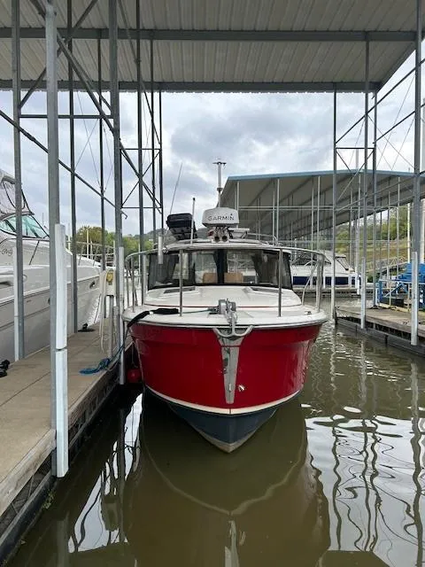 Slide: The Image of 2023 Ranger Tugs R23 boat docked in a marina, featuring a vibrant red hull. - 4