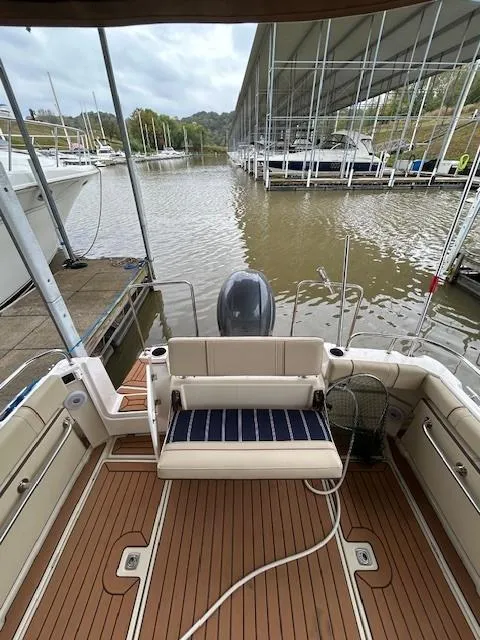 Slide: The Image of 2023 Ranger Tugs R23 boat with wooden deck, docked at a marina. - 8