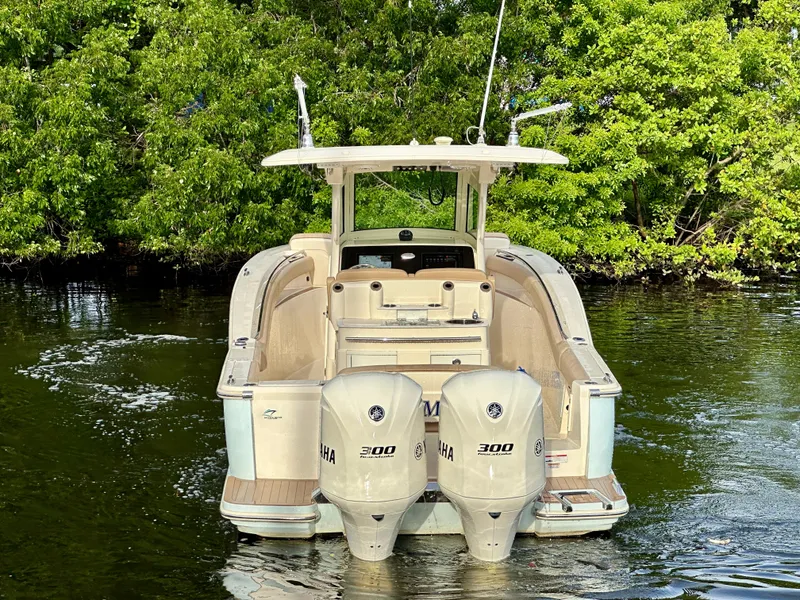 Slide: The Image of 2021 Scout 305 LXF boat with twin Yamaha engines on water. - 10