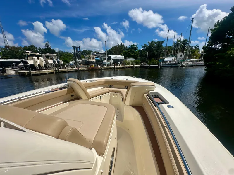 Slide: The Image of 2021 Scout 305 LXF boat docked in a sunny marina. - 3