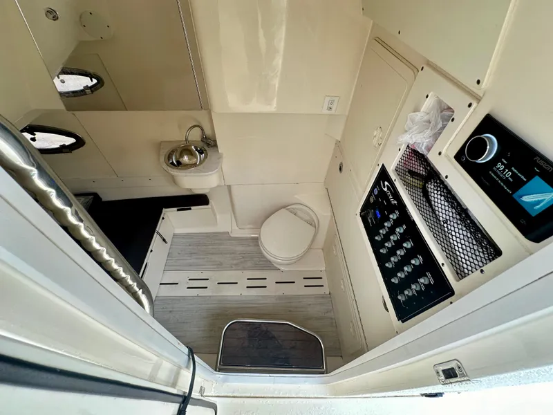 Slide: The Image of Interior of 2021 Scout 305 LXF boat with sink, toilet, and control panel. - 8
