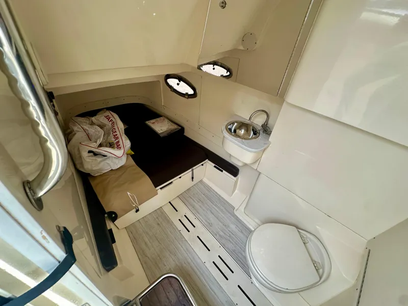 Slide: The Image of 2021 Scout 305 LXF cabin interior with bed, sink, and toilet. - 9