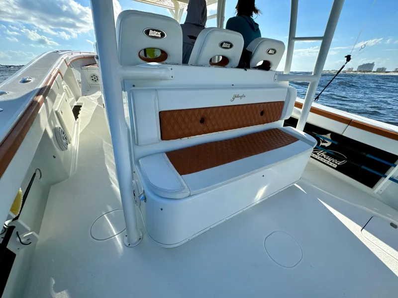 Slide: The Image of 2015 Yellowfin 42 boat interior with cushioned seating and ocean view. - 28