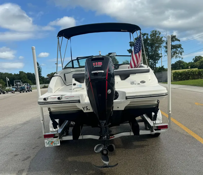 Slide: The Image of 2017 Sea Ray 19 SPX boat with outboard motor on trailer, American flag displayed. - 6