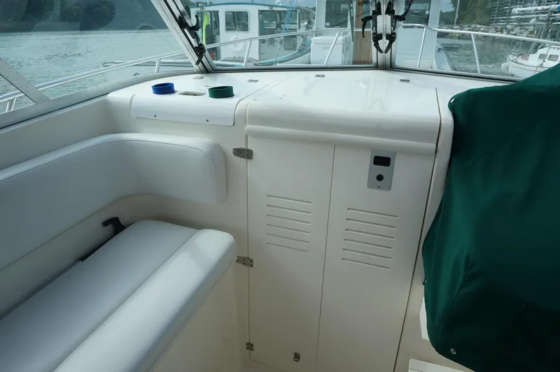 Slide: The Image of 2002 Pursuit 2865 Denali boat interior with seating and storage compartments. - 15