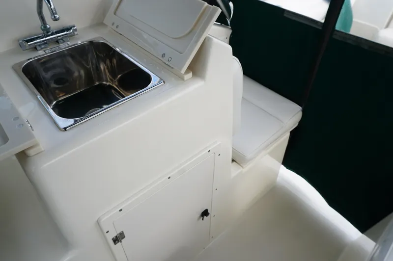 Slide: The Image of 2002 Pursuit 2865 Denali boat interior with sink and seating area. - 26