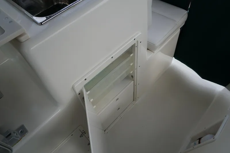 Slide: The Image of 2002 Pursuit 2865 Denali boat interior with storage compartment and seating area. - 27