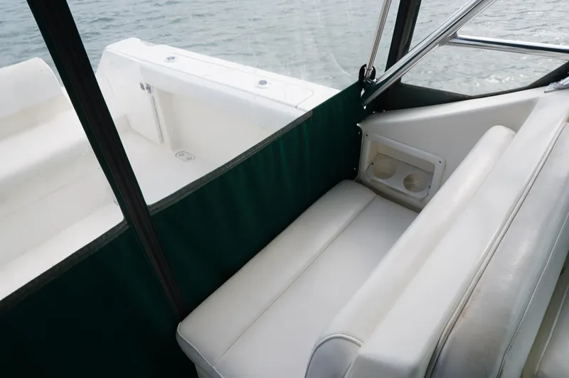 Slide: The Image of 2002 Pursuit 2865 Denali boat interior with white seating and green trim. - 28