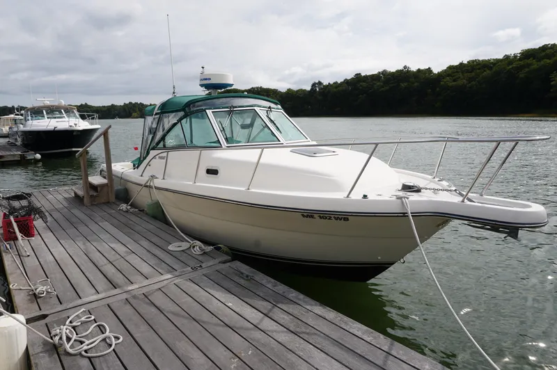 Slide: The Image of 2002 Pursuit 2865 Denali boat docked on a calm lake. - 3