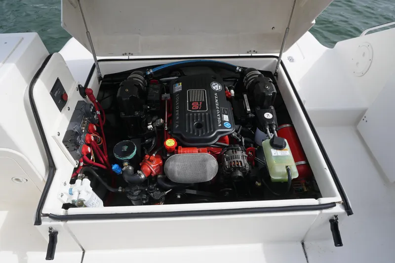 Slide: The Image of Engine compartment of a 2002 Pursuit 2865 Denali boat, showcasing detailed mechanical components. - 31