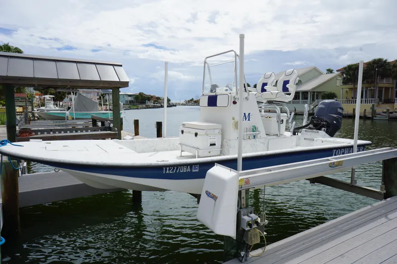 Slide: The Image of 2008 Marshall 21 Topwater Sport boat docked on a lift in a marina. - 0