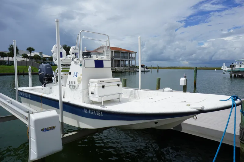 Slide: The Image of 2008 Marshall 21 Topwater Sport boat docked by waterfront. - 1