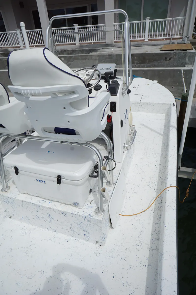 Slide: The Image of 2008 Marshall 21 Topwater Sport boat with dual white seats and steering console. - 11