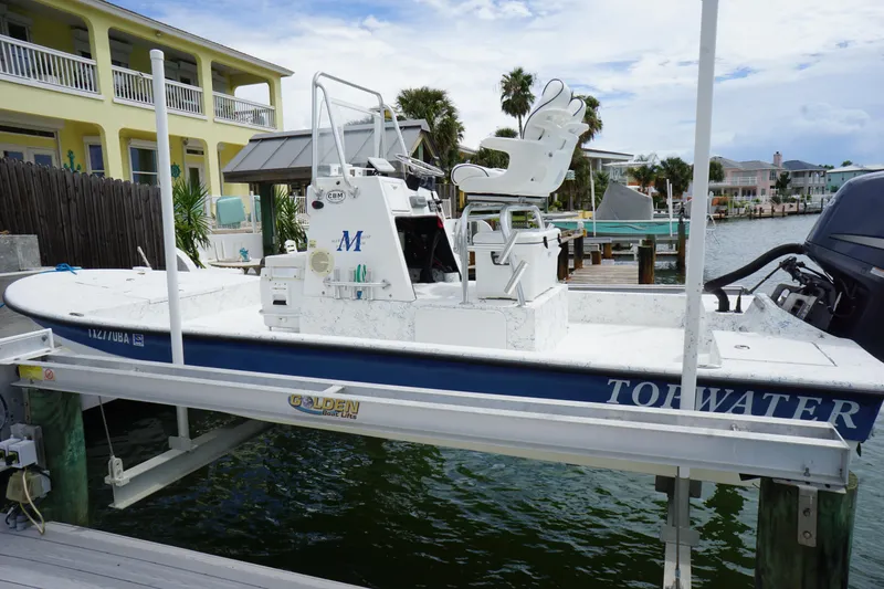 Slide: The Image of 2008 Marshall 21 Topwater Sport boat docked by waterfront homes. - 2