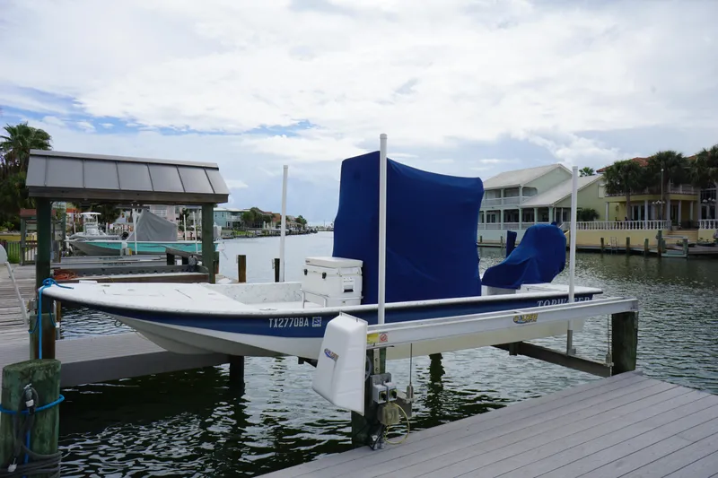 Slide: The Image of 2008 Marshall 21 Topwater Sport boat docked with blue cover in a marina. - 3