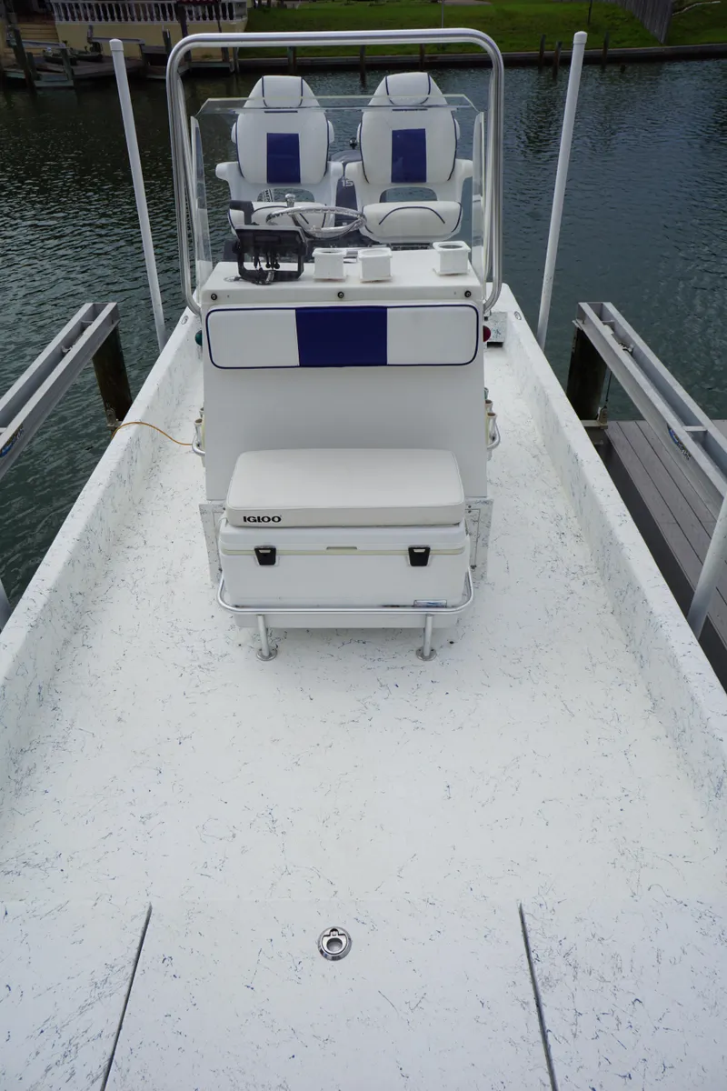 Slide: The Image of 2008 Marshall 21 Topwater Sport boat with dual seating and console on calm water. - 5