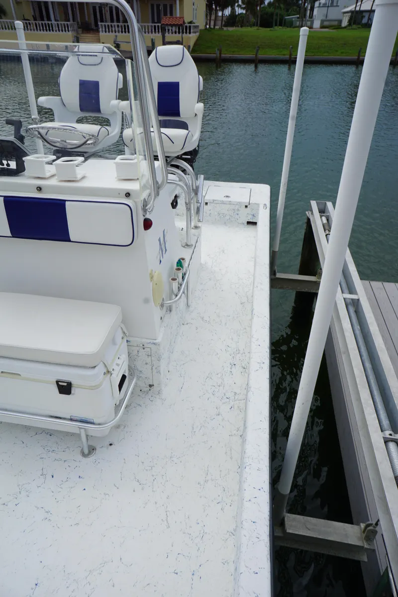 Slide: The Image of 2008 Marshall 21 Topwater Sport boat docked by the water. - 6