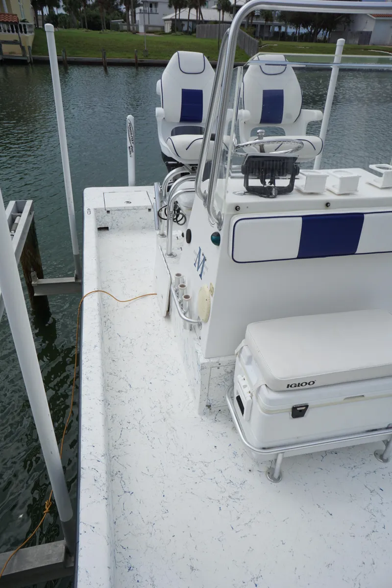Slide: The Image of 2008 Marshall 21 Topwater Sport boat with dual seats and console, docked by the water. - 7