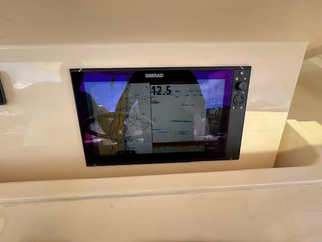 Slide: The Image of Simrad navigation display on 2020 Grady-White Canyon 376 boat dashboard. - 28