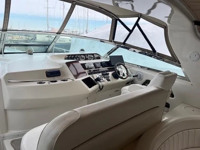Slide: The Image of Interior of 1995 Sea Ray 450 Sundancer yacht with modern helm and seating. - 10