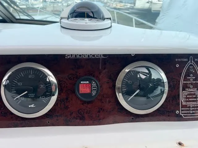 Slide: The Image of Dashboard of a 1995 Sea Ray 450 Sundancer boat with gauges and controls. - 12
