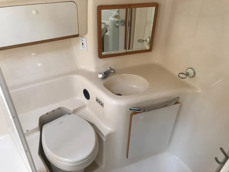 Slide: The Image of Bathroom interior of 1995 Sea Ray 450 Sundancer yacht, featuring sink and toilet. - 27