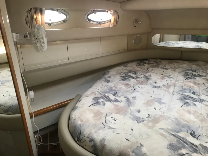 Slide: The Image of Interior cabin of 1995 Sea Ray 450 Sundancer with bed and porthole windows. - 29