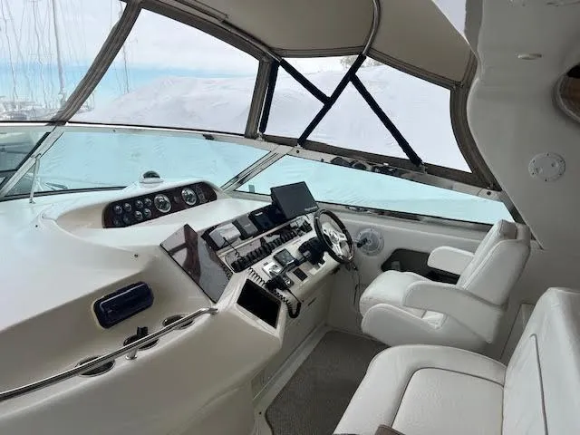 Slide: The Image of Interior helm of 1995 Sea Ray 450 Sundancer yacht with modern controls and seating. - 3