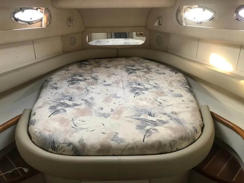 Slide: The Image of Cozy cabin interior of 1995 Sea Ray 450 Sundancer with floral-patterned bed. - 30
