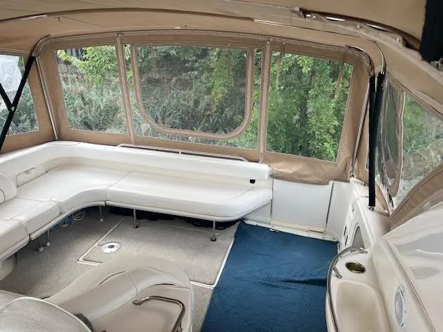 Slide: The Image of Interior of 1995 Sea Ray 450 Sundancer with white seating and large windows. - 49