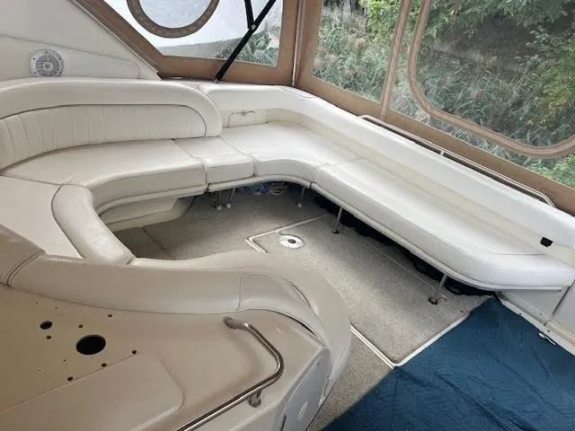 Slide: The Image of 1995 Sea Ray 450 Sundancer interior with white leather seating and carpeted floor. - 8